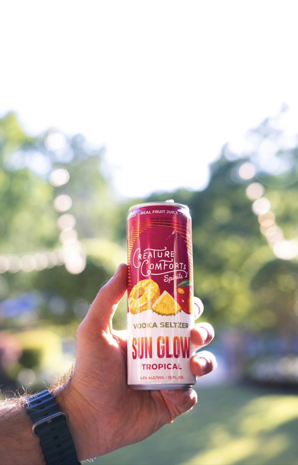 Hand holding Creature Comforts Sun Glow can